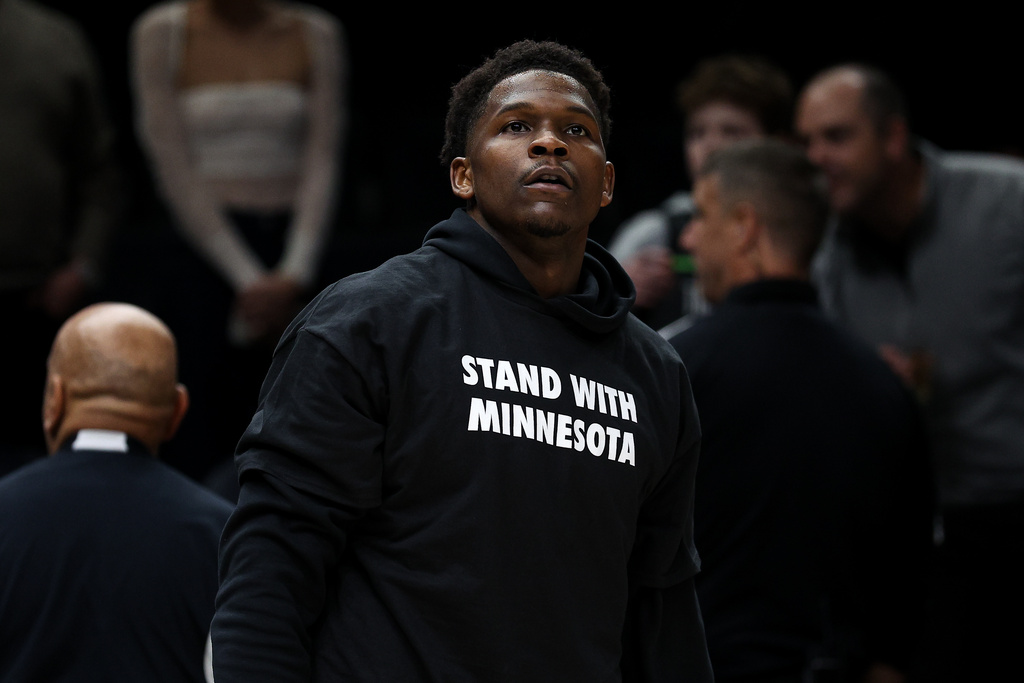 Minnesota Timberwolves guard Anthony Edwards looks on while wearing a shirt that reads "Stand With Minnesota" prior to an NBA basketball game against the Oklahoma City Thunder, Thursday, Jan. 29, 2026, in Minneapolis. (AP Photo/Matt Krohn)
