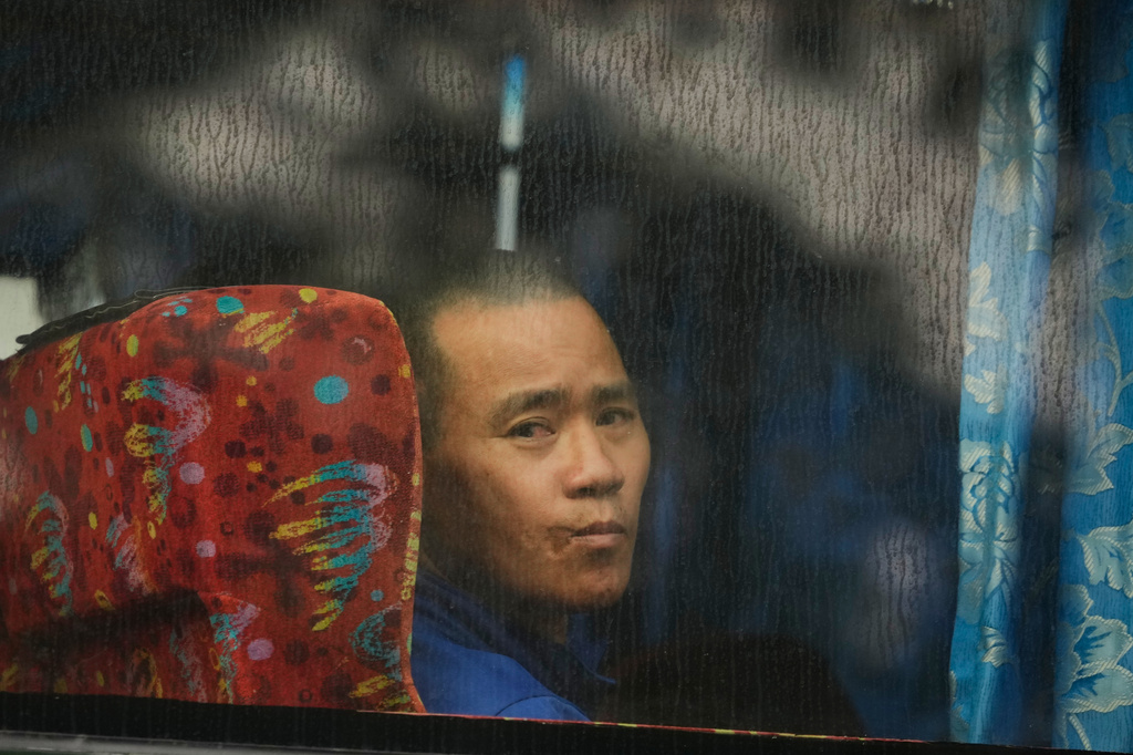 One of Myanmar nationals looks out from a bus in Manjung, Perak state of Malaysia, on Tuesday, Sept. 29, 2026. (AP Photo/Vincent Thian)