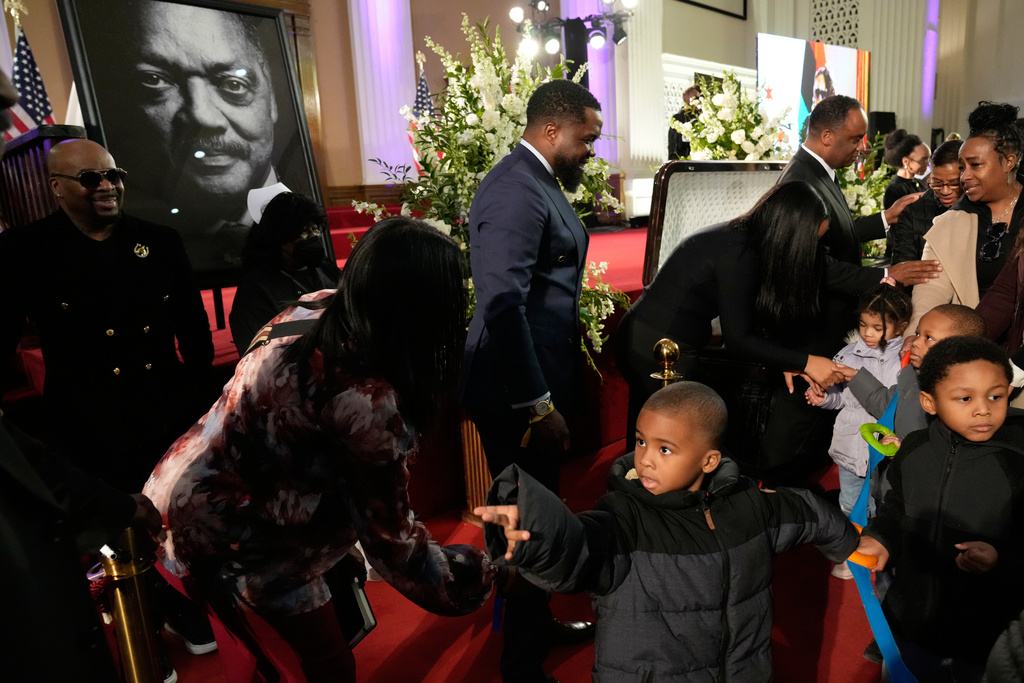 Children from Angels of Joy Academy are greeted during public visitation for the Rev. Jesse Jackson at at Rainbow PUSH Coalition headquarters in Chicago, Friday, Feb. 27, 2026. (AP Photo/Nam Y. Huh)