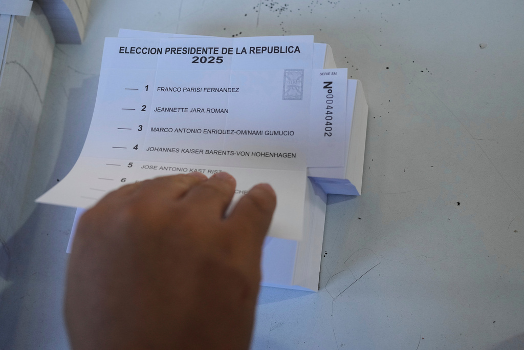 An electoral worker prepares ballots at a polling station during general elections in Santiago, Chile, Sunday, Nov. 16, 2025. (AP Photo/Natacha Pisarenko)