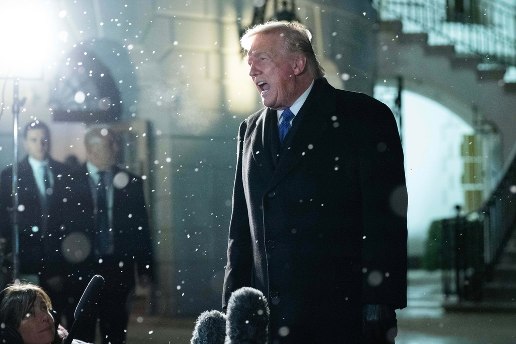 President Donald Trump speaks to reporters on the South Lawn before departing the White House, Friday, Feb. 6, 2026, in Washington. (AP Photo/Jose Luis Magana)