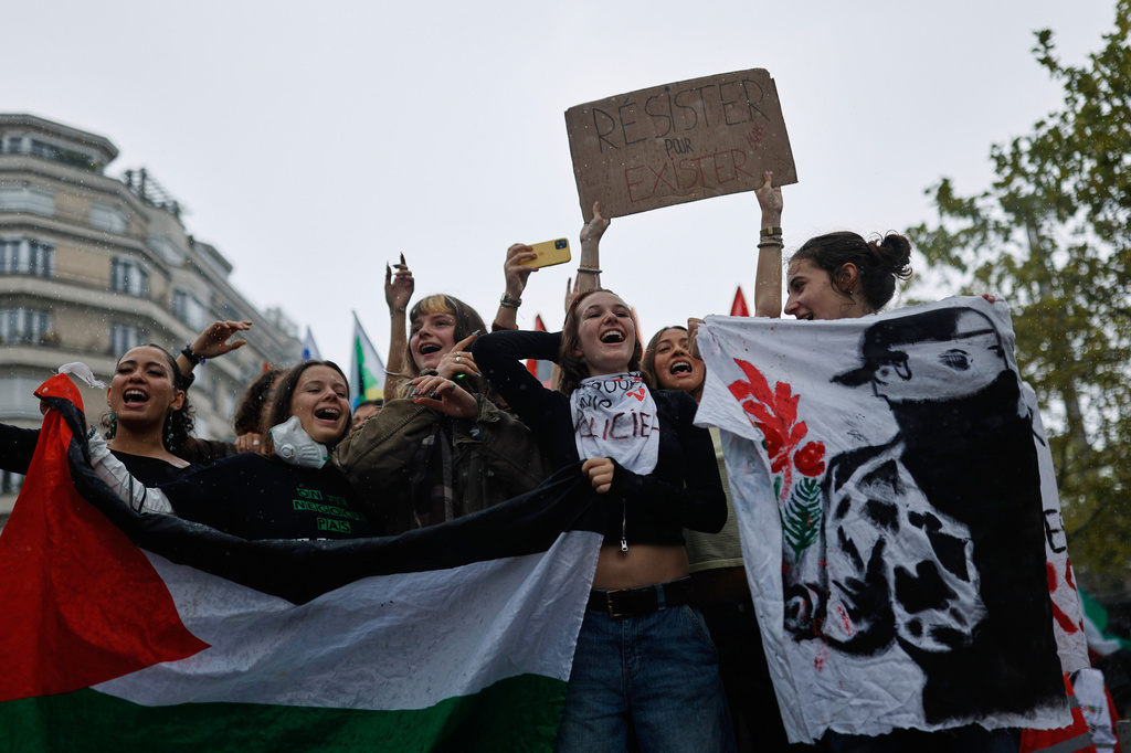 Students chant during a protest against under-resourced schools in Rennes, France, Tuesday, Oct. 13, 2026. The placard reads: "resist to exist." (AP Photo/Jeremias Gonzalez)