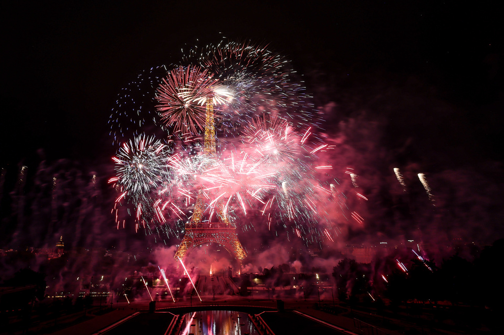 Fireworks and drones illuminate the Eiffel Tower in Paris, during the eve of Bastille Day celebrations, Monday, July 13, 2026. (AP Photo/Thomas Padilla)