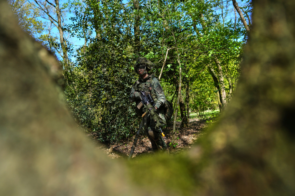 A member of the 10th Infantry Battalion Guard Security Corps National Reserve searches for enemy positions during a weekend exercise meant to hone military skills as the Netherlands beefs up its military with new recruits and volunteer reservists in Havelte, Netherlands, Saturday, April 25, 2026. (AP Photo/Peter Dejong)