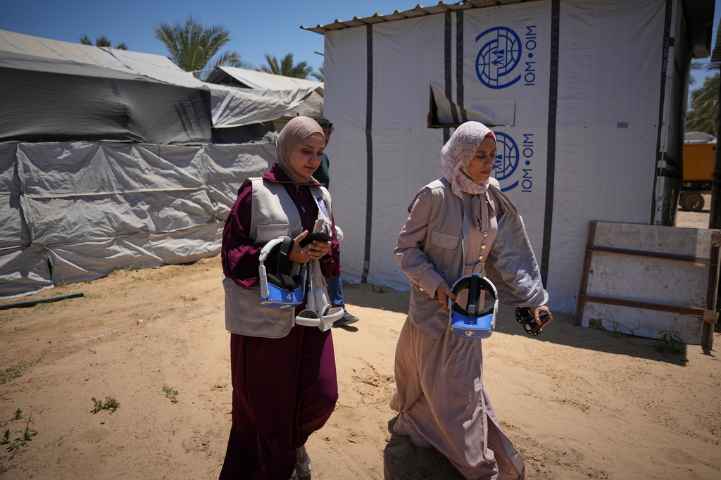 Mental health professionals arrive at a tent carrying virtual reality headsets to begin therapy sessions in Zawaida, central Gaza Strip, Wednesday, June 17, 2026. (AP Photo/Abdel Kareem Hana)