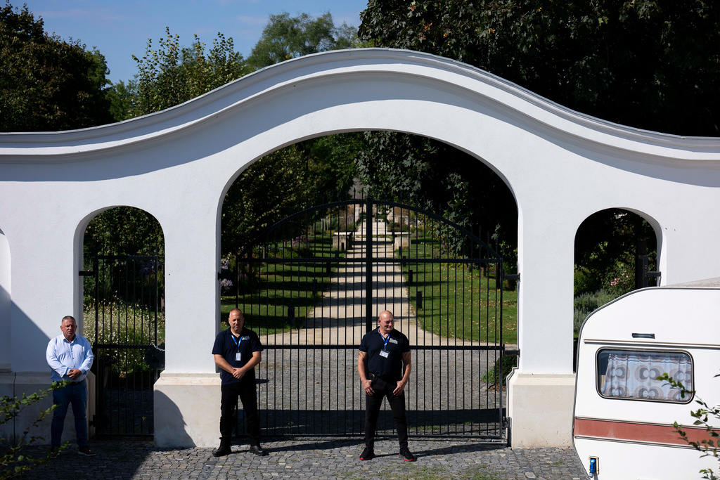 Security guards stand at the gates of Hatvanpuszta, a country estate linked to alleged corruption involving Prime Minister Viktor Orbán, near Alcsútdoboz in Hungary, Saturday, Sept. 27, 2025. (AP Photo/Denes Erdos)