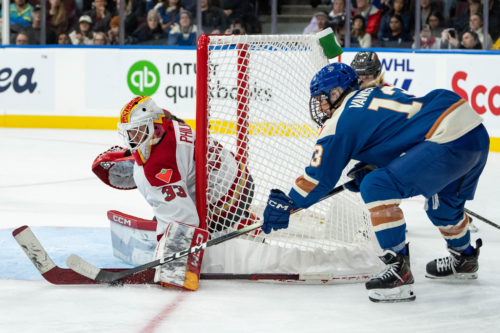 Ottawa Charge goaltender Gwyneth Philips (33) stops Vancouver Goldeneyes' Tereza Vanisova (13) during the third period of a PWHL hockey game in Vancouver, British Columbia, Tuesday, Dec. 16, 2025. (Ethan Cairns/The Canadian Press via AP)