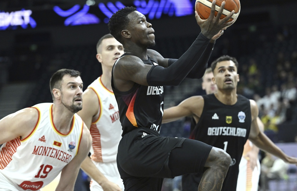 Germany's Dennis Schroder, front, plays the ball during the FIBA EuroBasket 2025 group B basketball match between Montenegro and Germany in Tampere, Finland, Wednesday, Aug. 27, 2025. (Heikki Saukkomaa/Lehtikuva via AP)