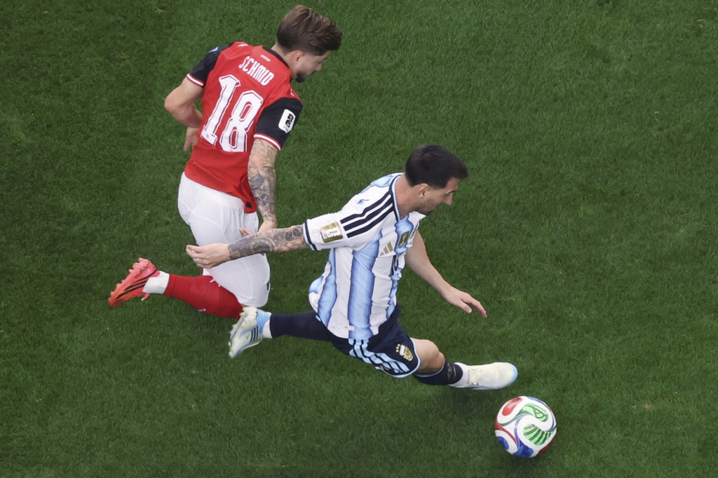 Argentina's Lionel Messi (10) controls the ball while being pursued by Austria's Romano Schmid (18) during the World Cup Group J soccer match between Argentina and Austria in Arlington, Texas, near Dallas, Monday, June 22, 2026. (AP Photo/Sam Hodde)