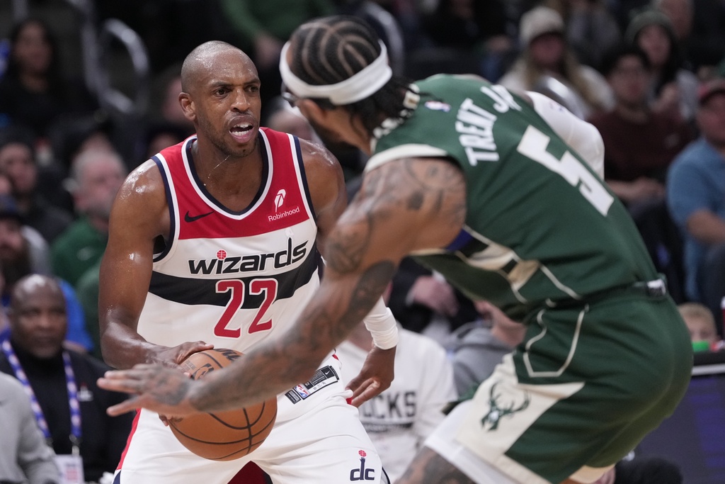 Washington Wizards' Khris Middleton fouls Milwaukee Bucks' Gary Trent Jr. during the first half of an NBA basketball game Wednesday, Oct. 22, 2025, in Milwaukee. (AP Photo/Morry Gash)