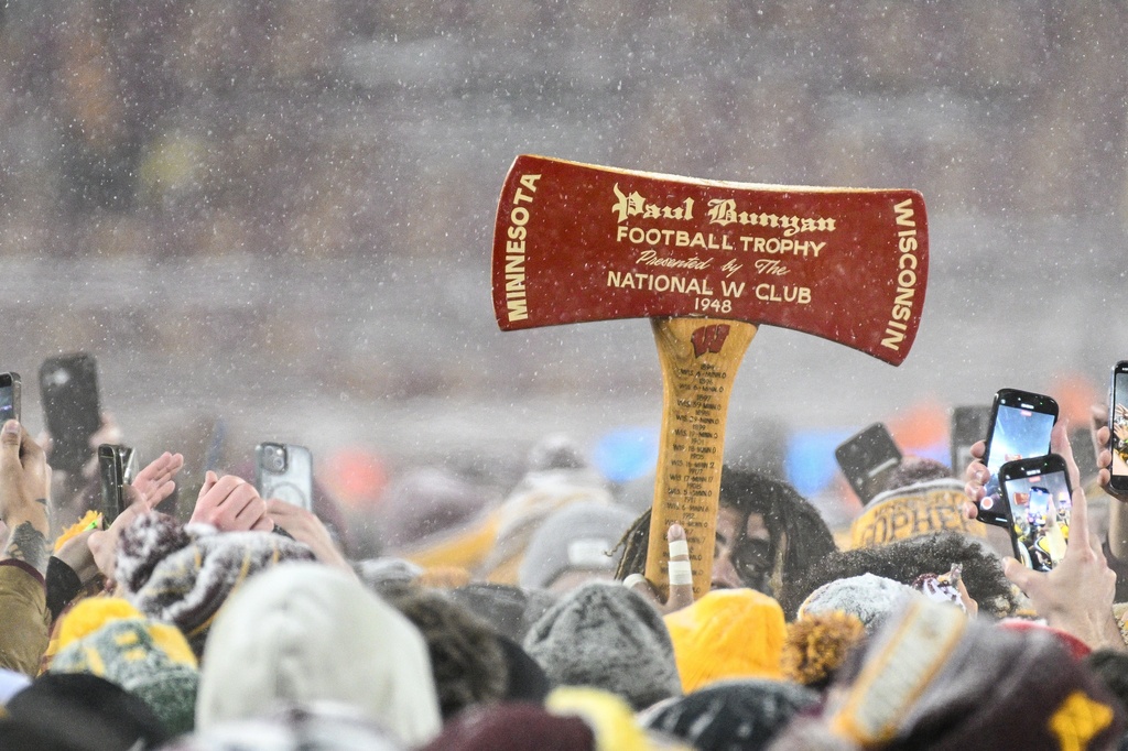 Minnesota players hold up the Paul Bunyan Football Trophy after defeating Wisconsin during an NCAA college football game Saturday, Nov. 29, 2025, in Minneapolis. (AP Photo/Tom Baker)