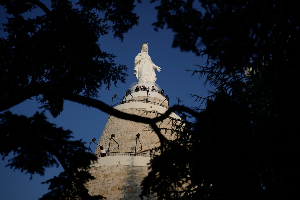 Pilgrims pray at the feet of a shrine to the Virgin Mary in Harissa east Beirut, Lebanon, Sunday, Nov. 9, 2025. (AP Photo/Hassan Ammar)