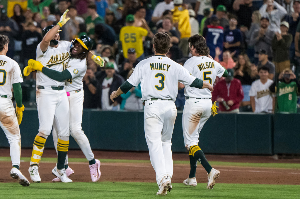 The Athletics celebrate winning a baseball game against the Los Angeles Angels in West Sacramento, Calif., Friday, June 19, 2026. (AP Photo/Nic Coury)
