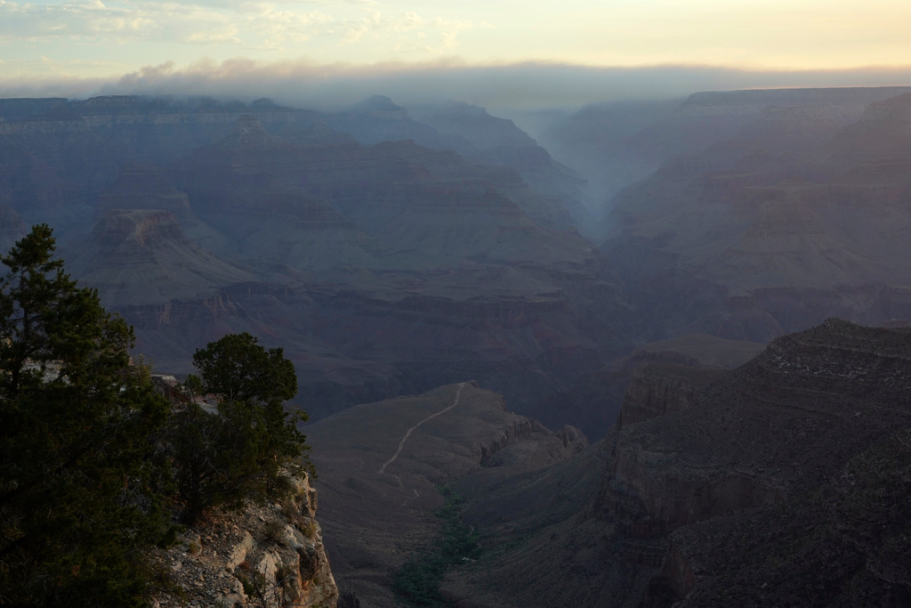 FILE - Smoke from the Dragon Bravo Fire moves over the Grand Canyon from the North Rim, July 15, 2025, in Grand Canyon National Park, Ariz. (AP Photo/Ross D. Franklin, File)
