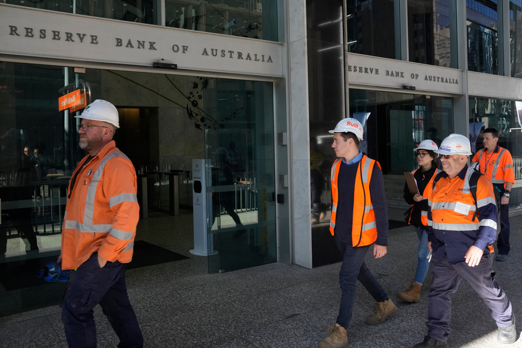 FILE - Workers in high visibility clothing walk past the Reserve Bank of Australia in Sydney, Nov. 1, 2022. (AP Photo/Rick Rycroft, File)