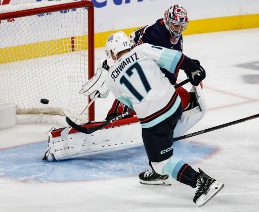 Seattle Kraken's Jaden Schwartz (17) scores on Winnipeg Jets goaltender Connor Hellebuyck (37) during second period NHL action in Winnipeg on Thursday, Oct. 23, 2025. (John Woods/The Canadian Press via AP) Seattle Kraken's Jaden Schwartz (17) scores on Winnipeg Jets goaltender Connor Hellebuyck (37) during second period NHL action in Winnipeg on Thursday, Oct. 23, 2025. (John Woods/The Canadian Press via AP)