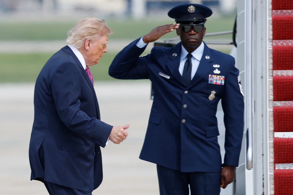 President Donald Trump, left, gestures as he walks from Marine One to board Air Force One, during his departure at Joint Base Andrews, Md., Thursday, August. 27, 2026. (AP Photo/Luis M. Alvarez)