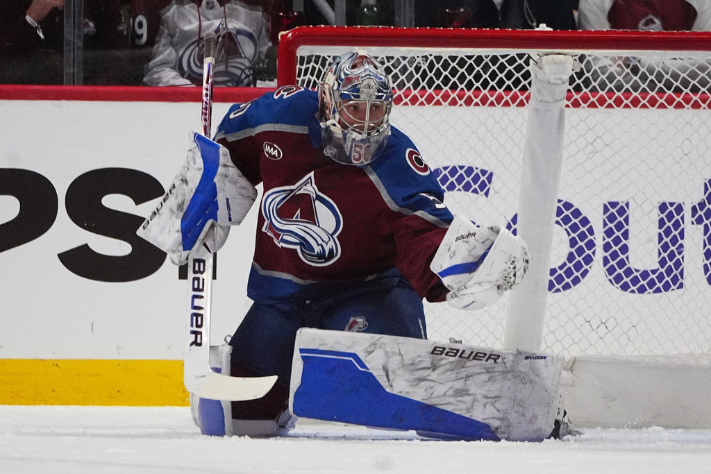 Colorado Avalanche goaltender Trent Miner makes a glove save in the first period of an NHL hockey game against the Columbus Blue Jackets Saturday, Jan. 10, 2026, in Denver. (AP Photo/David Zalubowski)