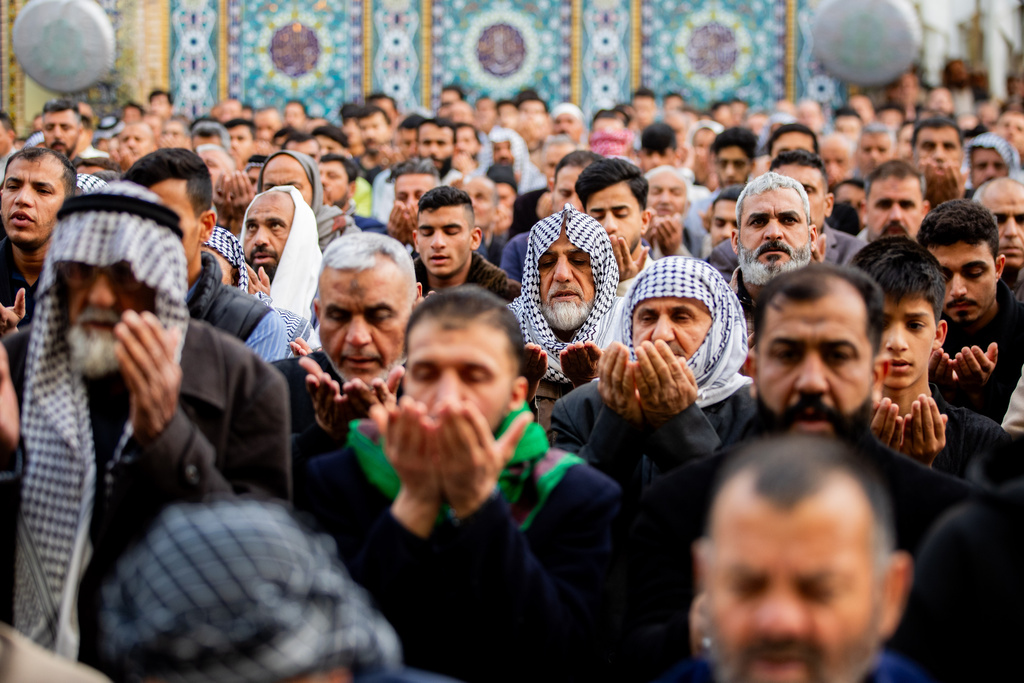 Iraqi Shiite Muslims gather for an Eid al-Fitr prayer at the shrine of Imam Ali shrine in Najaf, Saturday, March 21, 2026. The Eid al-Fitr holiday marks the end of the holy fasting month of Ramadan. (AP Photo/Anmar Khalil)