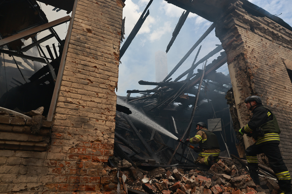 Rescue workers put out a fire at a building destroyed after a Russian strike on Zaporizhzhia, Ukraine, on Friday, June 26, 2026. (AP Photo/Evgeniy Maloletka)