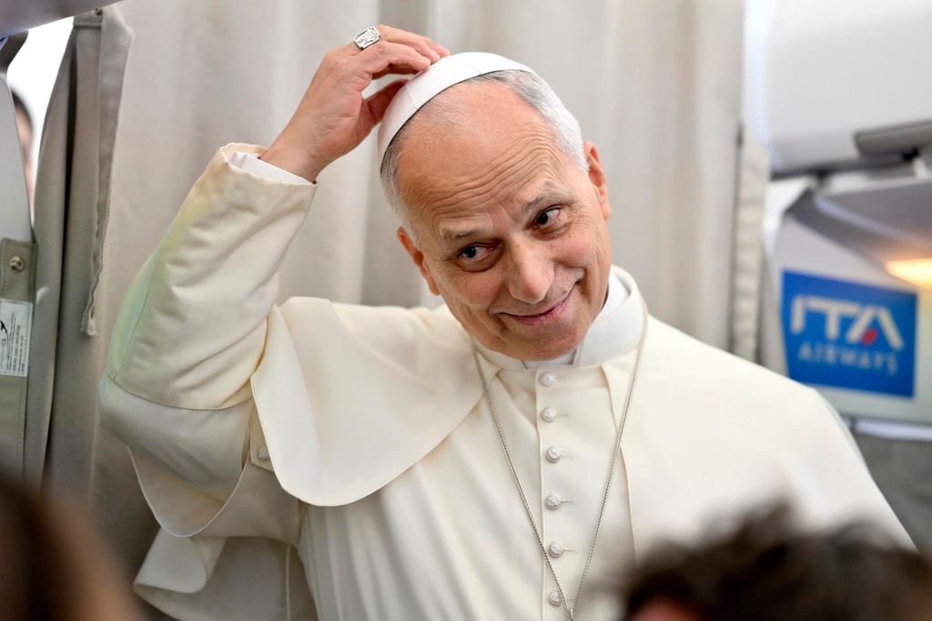 Pope Leo XIV talks to reporters aboard an airplane as he returns from a six-day visit to Turkey and Lebanon, Tuesday, Dec. 2, 2025. (Alessandro Di Meo/Pool Photo via AP)