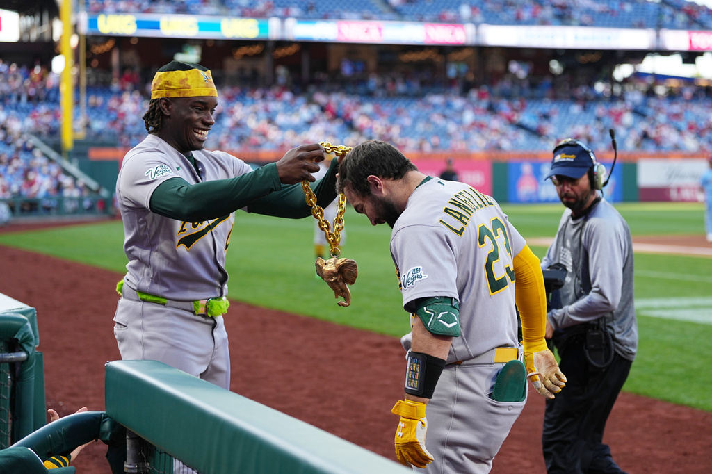 Athletics' Shea Langeliers (23) celebrates his two-run home run off of Philadelphia Phillies pitcher Andrew Painter with teammate Lawrence Butler during the first inning of a baseball game, Thursday, May 7, 2026, in Philadelphia. (AP Photo/Matt Rourke)