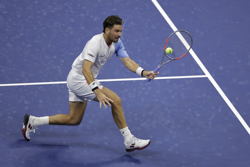 Cameron Norrie, of Great Britain, returns a shot to Novak Djokovic, of Serbia, during the third round of the U.S . Open tennis championships, Friday, Aug. 29, 2025, in New York. (AP Photo/Adam Hunger)