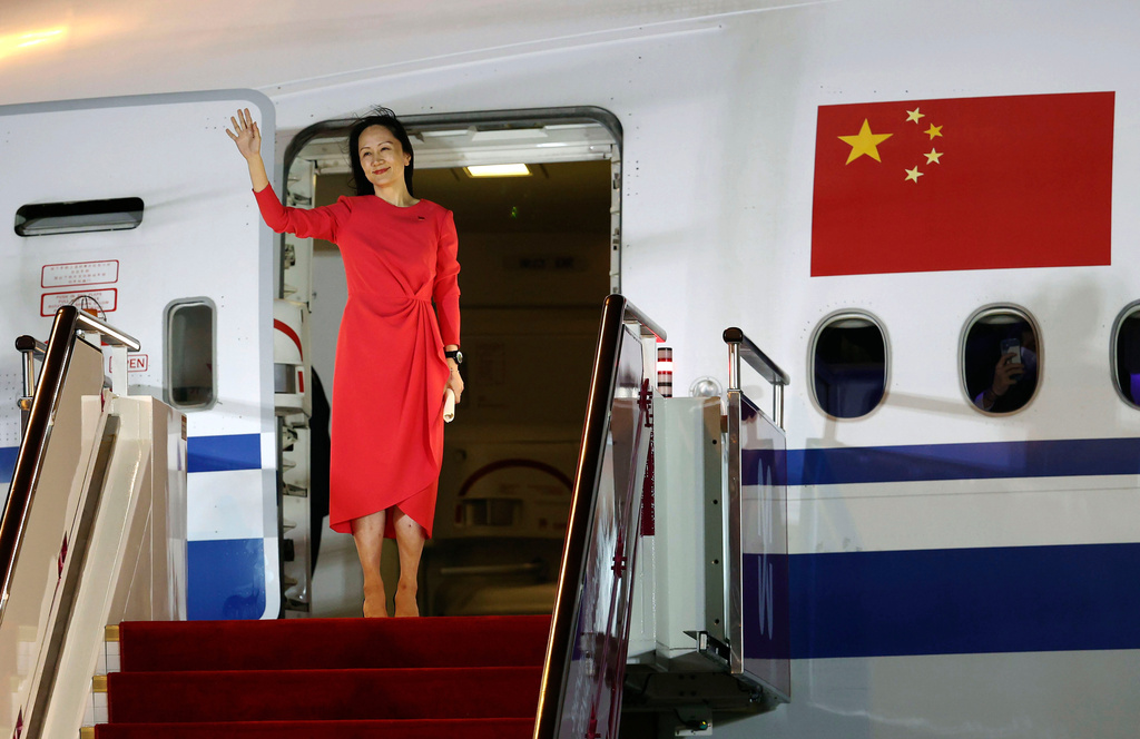 FILE - In this photo released by China's Xinhua News Agency, Huawei CFO Meng Wanzhou waves as she steps out of an airplane after arriving from Canada at Shenzhen Bao'an International Airport in Shenzhen in southern China's Guangdong Province, Saturday, Sept. 25, 2021. (Jin Liwang/Xinhua via AP, File)