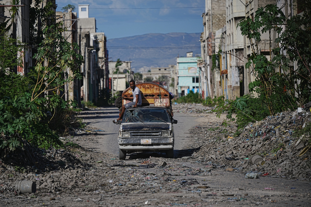 A local travels on public transportation through a gang-controlled area of Port-au-Prince, Haiti, Monday, Jan. 19, 2026. (AP Photo/Odelyn Joseph)