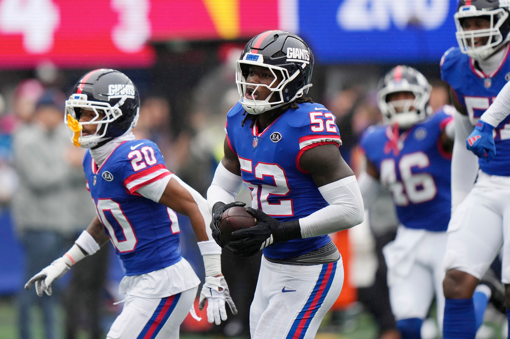 New York Giants linebacker Arvell Reese (52) celebrates his interception against the Arizona Cardinals with Giants cornerback Greg Newsome II (20) during an NFL football game, in East Rutherford, N.J., Sunday, Oct. 4, 2026. (AP Photo/Seth Wenig)