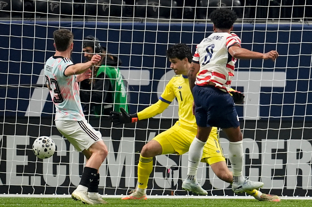 United States' Weston McKennie (8) scores past Belgium' goalkeeper Senne Lammens during the first half of an international friendly soccer match, Saturday, March 28, 2026, in Atlanta. (AP Photo/Mike Stewart)