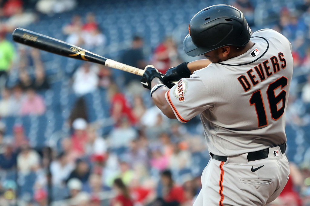 San Francisco Giants' Rafael Devers hits an RBI double during the second inning of a baseball game against the Washington Nationals, Friday, April 17, 2026, in Washington. (AP Photo/Daniel Kucin Jr.)