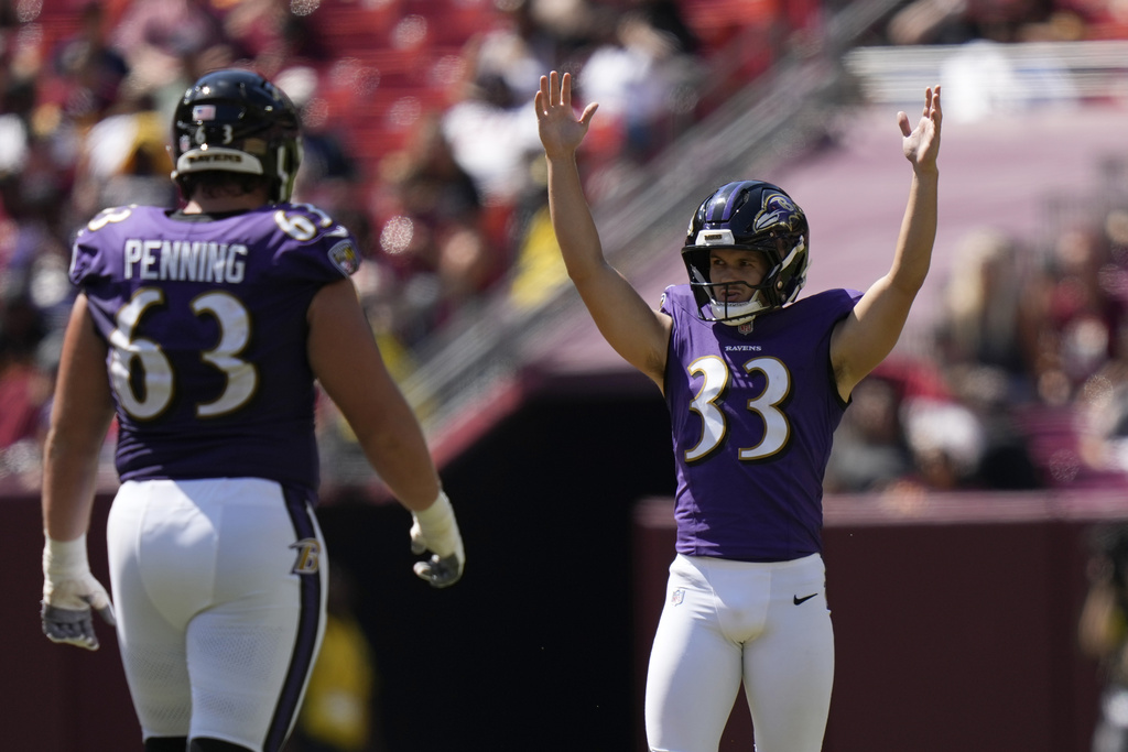 Baltimore Ravens kicker Tyler Loop celebrates after making a 61-yard field goal as guard Jared Penning (63) watches during the second half of a preseason NFL football game against the Washington Commanders Saturday, Aug. 23, 2025, in Landover, Md. (AP Photo/Stephanie Scarbrough)