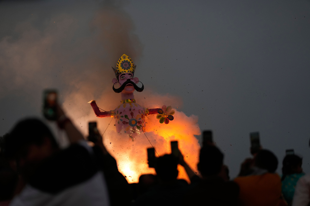 Indian people watch an effigy of demon king Ravana's son Meghnath go up in flames marking the end of Dussehra festival in Jammu, India, Thursday, Oct.2, 2025.(AP Photo/Channi Anand)