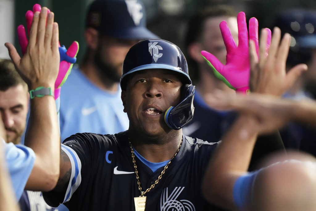 Kansas City Royals' Salvador Perez celebrates in the dugout after hitting a solo home run during the fourth inning of a baseball game against the Chicago White Sox, Friday, Aug. 15, 2025, in Kansas City, Mo. (AP Photo/Charlie Riedel)
