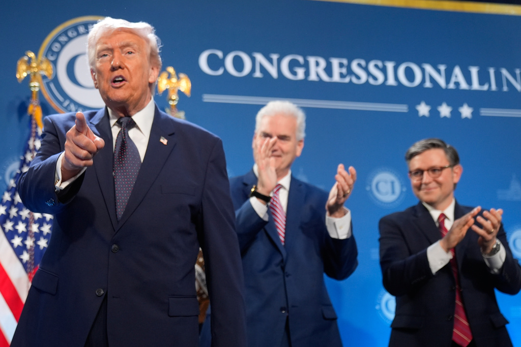 President Donald Trump gestures as Rep. Tom Emmer, R-Minn., and House Speaker Mike Johnson of La., applaud at the Republican Members Issues Conference, Monday, March 9, 2026, at Trump National Doral Miami in Doral, Fla. (AP Photo/Mark Schiefelbein)