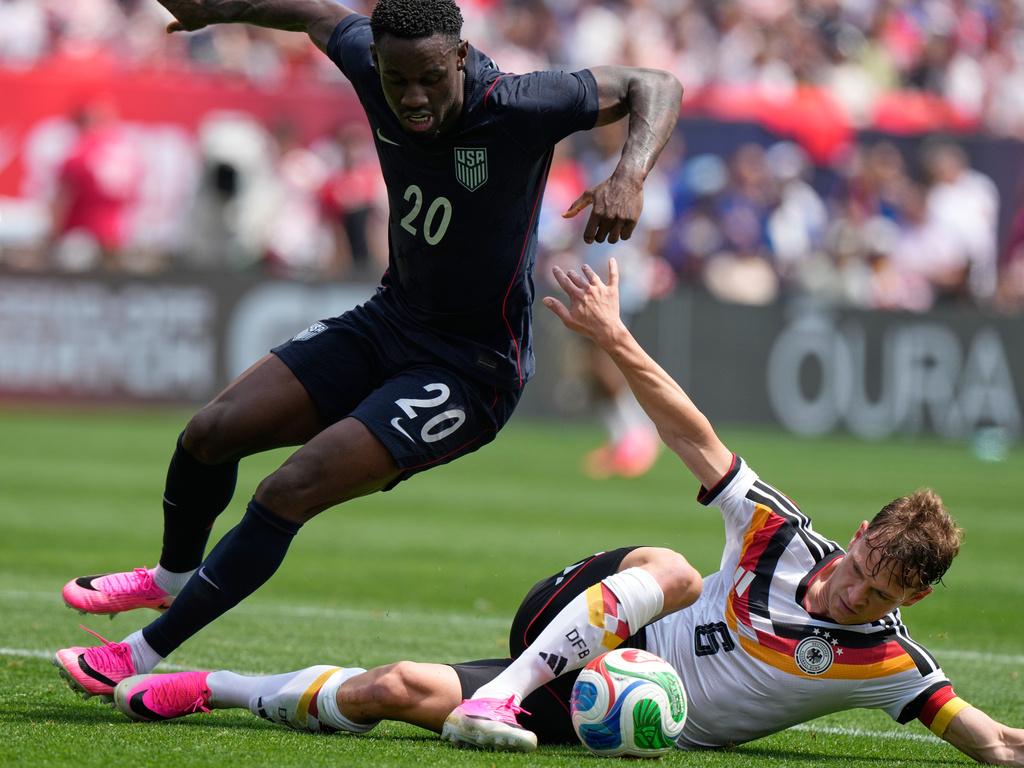 Germany midfielder Joshua Kimmich, right, controls the ball under United States forward Folarin Balogun during the first half of an international friendly soccer match in Chicago, Saturday, June 6, 2026. (AP Photo/Nam Y. Huh)