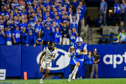 BYU wide receiver Chase Roberts (2) makes the catch over the defense of West Virginia cornerback Michael Coats Jr. (3) during the first half of an NCAA college football game, Friday, Oct. 3, 2025, in Provo, Utah. (AP Photo/Tyler Tate) BYU wide receiver Chase Roberts (2) makes the catch over the defense of West Virginia cornerback Michael Coats Jr. (3) during the first half of an NCAA college football game, Friday, Oct. 3, 2025, in Provo, Utah. (AP Photo/Tyler Tate)
