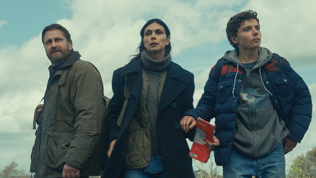 This image released by Lionsgate shows Gerard Butler, from left, Morena Baccarin, and Roman Griffin Davis in a scene from "Greenland 2: Migration." (Lionsgate via AP)
