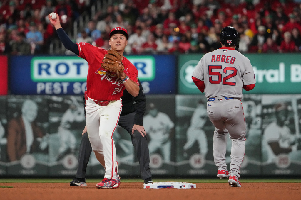 Boston Red Sox's Wilyer Abreu (52) is out at second as St. Louis Cardinals' JJ Wetherholt (26) commits a throwing error trying unsuccessfully to turn the double play allowing a run to score during the fourth inning of a baseball game Friday, April 10, 2026, in St. Louis. (AP Photo/Jeff Roberson)