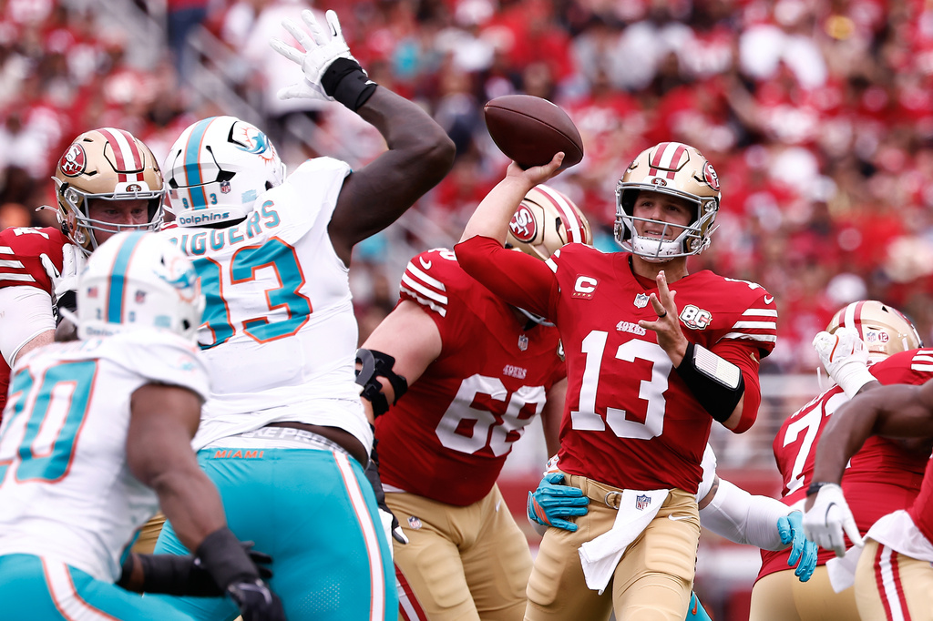 San Francisco 49ers quarterback Brock Purdy (13) passes as Miami Dolphins defensive tackle Zeek Biggers (93) applies pressure during the first half of an NFL football game in Santa Clara, Calif., Sunday, Sept. 20, 2026. (AP Photo/Kelley L. Cox)