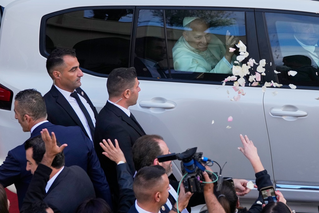 Rose petals are scattered to Pope Leo XIV as he leaves after visiting the Psychiatric Hospital of the Cross in the town of Jal el-Dib, north of Beirut, Lebanon, Tuesday, Dec. 2, 2025. (AP Photo/Hassan Ammar)