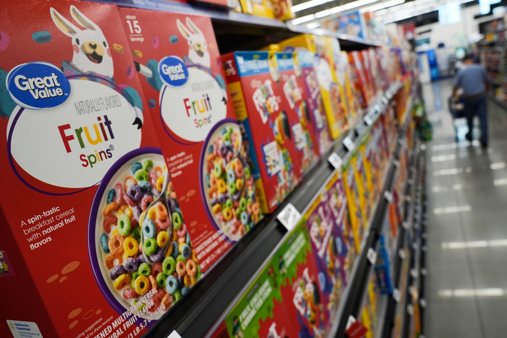 A customer walks past a display of Great Value brand cereal at a Walmart Neighborhood Market, Friday, Sept. 26, 2025, in Bentonville, Ark. (AP Photo/Charlie Riedel)