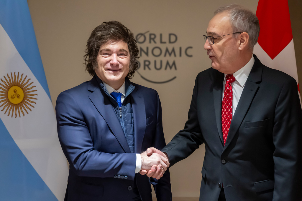 Argentina's President Javier Milei, left, shakes hands with Switzerland's Federal President Guy Parmelin, right, prior to a bilateral meeting on the sideline of the 56th annual meeting of the World Economic Forum, WEF, in Davos, Switzerland, Wednesday, Jan. 21, 2026. (Laurent Gillieron/Keystone pool via AP)