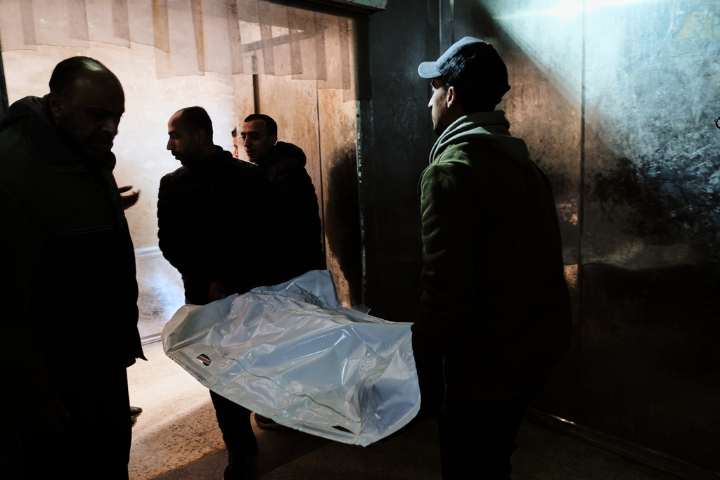 Relatives carry the bodies of members of the Al-Atbash family, who were killed in an Israeli military strike, at Shifa Hospital in Gaza City Saturday, Jan. 31, 2026. (AP Photo/Jehad Alshrafi)