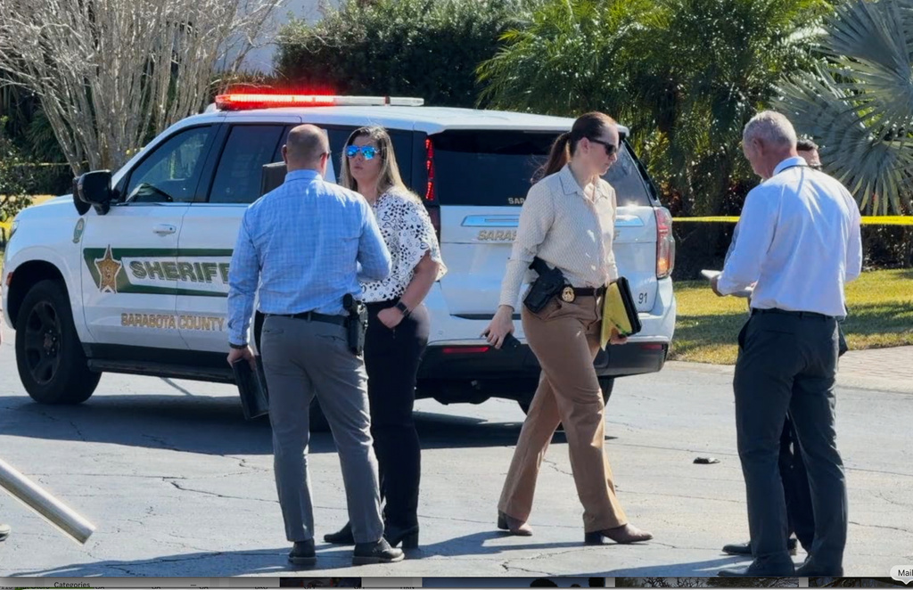 In this image from video provided by WFTS, law enforcement officers investigate a scene, Wednesday, Feb. 11, 2026, in Sarasota, Fla., which authorities say is connected to another crime scene, in Fort Lauderdale, Fla. (WFTS via AP)