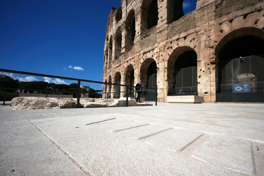 People walk in the new outdoor space created with travertine marble around the Colosseum during it's inauguration in Rome, Tuesday, March 17, 2026. (AP Photo/Andrew Medichini)