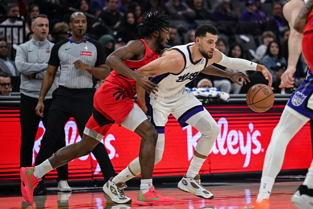 Toronto Raptors guard Immanuel Quickley (5) knocks the ball away from Sacramento Kings guard Zach LaVine (8) during the first half of an NBA basketball game, Wednesday, Jan. 21, 2026, in Sacramento, Calif. (AP Photo/Justine Willard)