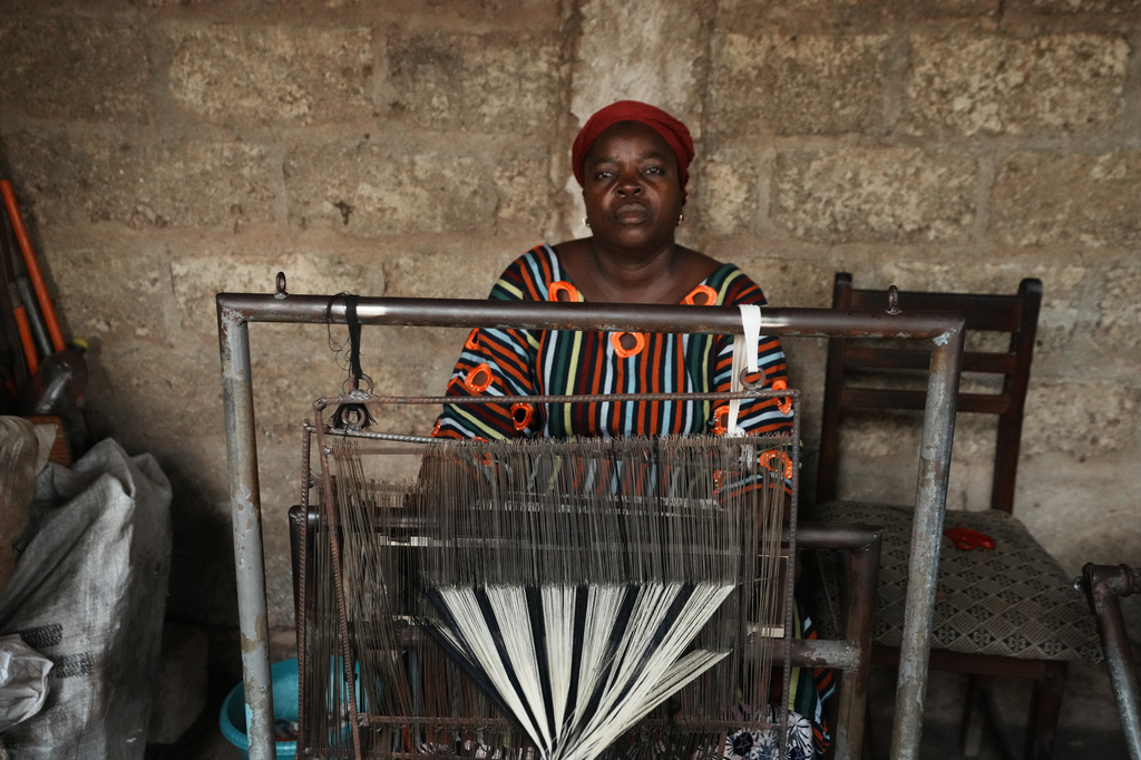 Chabi Baké, a mother of five, is photographed behind a weaving machine in Parakou, northern Benin, Saturday, May 16, 2026. (AP Photo/Sunday Alamba)
