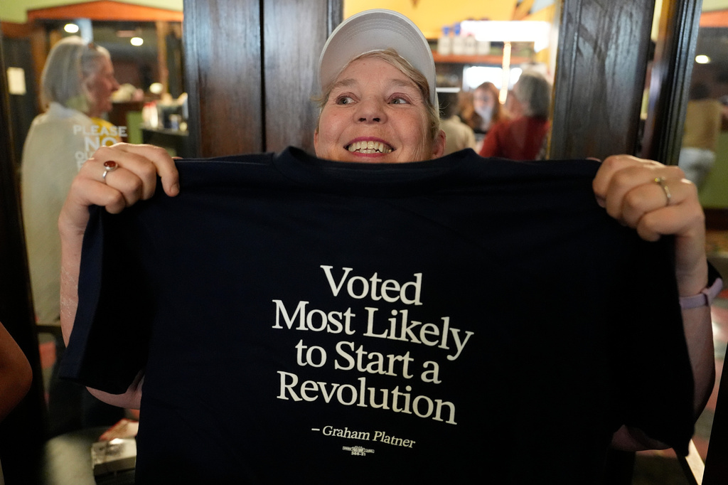 Jodi Edwards, a campaign volunteer for Graham Platner, Democratic candidate for U.S. Senate, shows off a t-shirt at a rally Friday, June 5, 2026, in Bar Harbor, Maine. (AP Photo/Robert F. Bukaty)